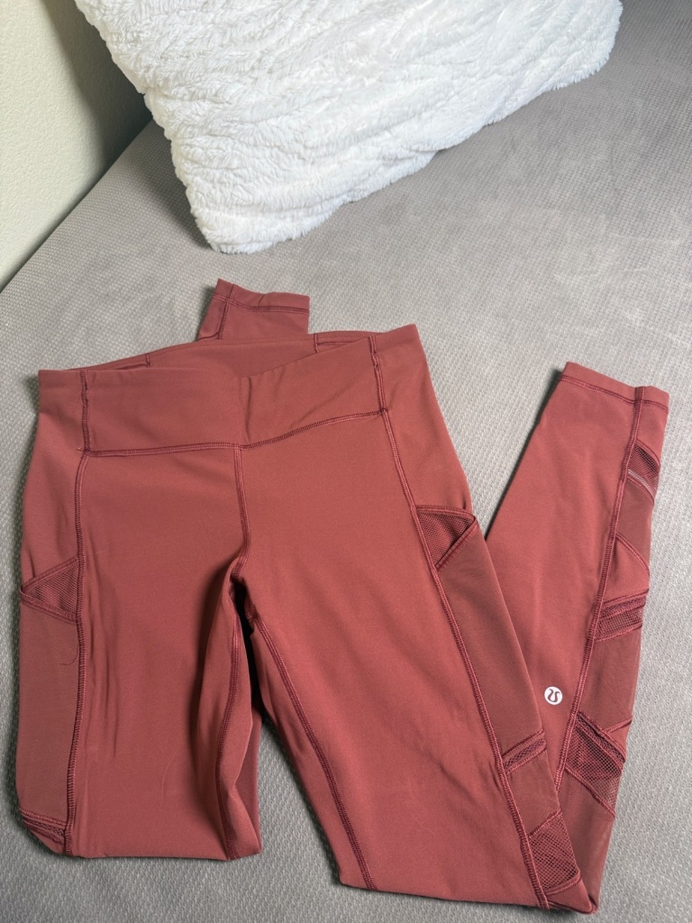 lululemon rust-colored athletic leggings with mesh panels